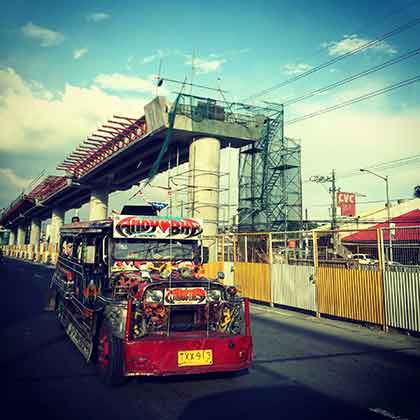 A photo of a Philippine jeepney on a street