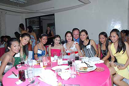 A photo of Filipino ladies sitting round a table